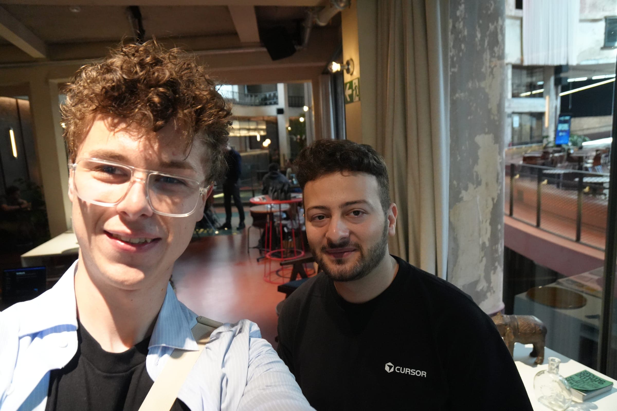 Cafe Cursor Ghent, 23 May 2026. Two attendees, one in a Cursor shirt.