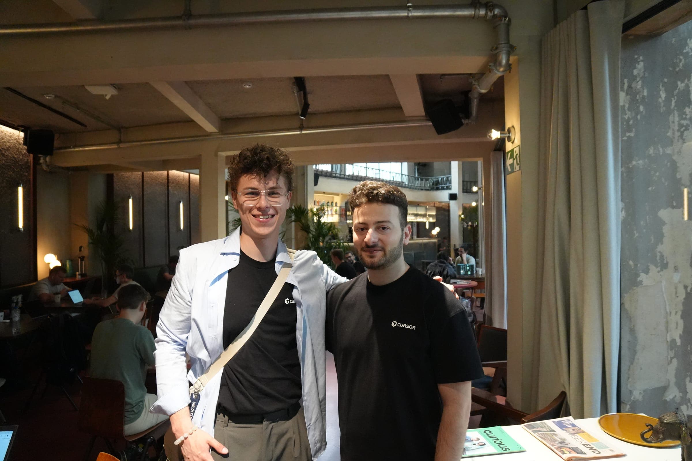 Cafe Cursor Ghent, 23 May 2026. Two builders in Cursor shirts at Bar Bougie.
