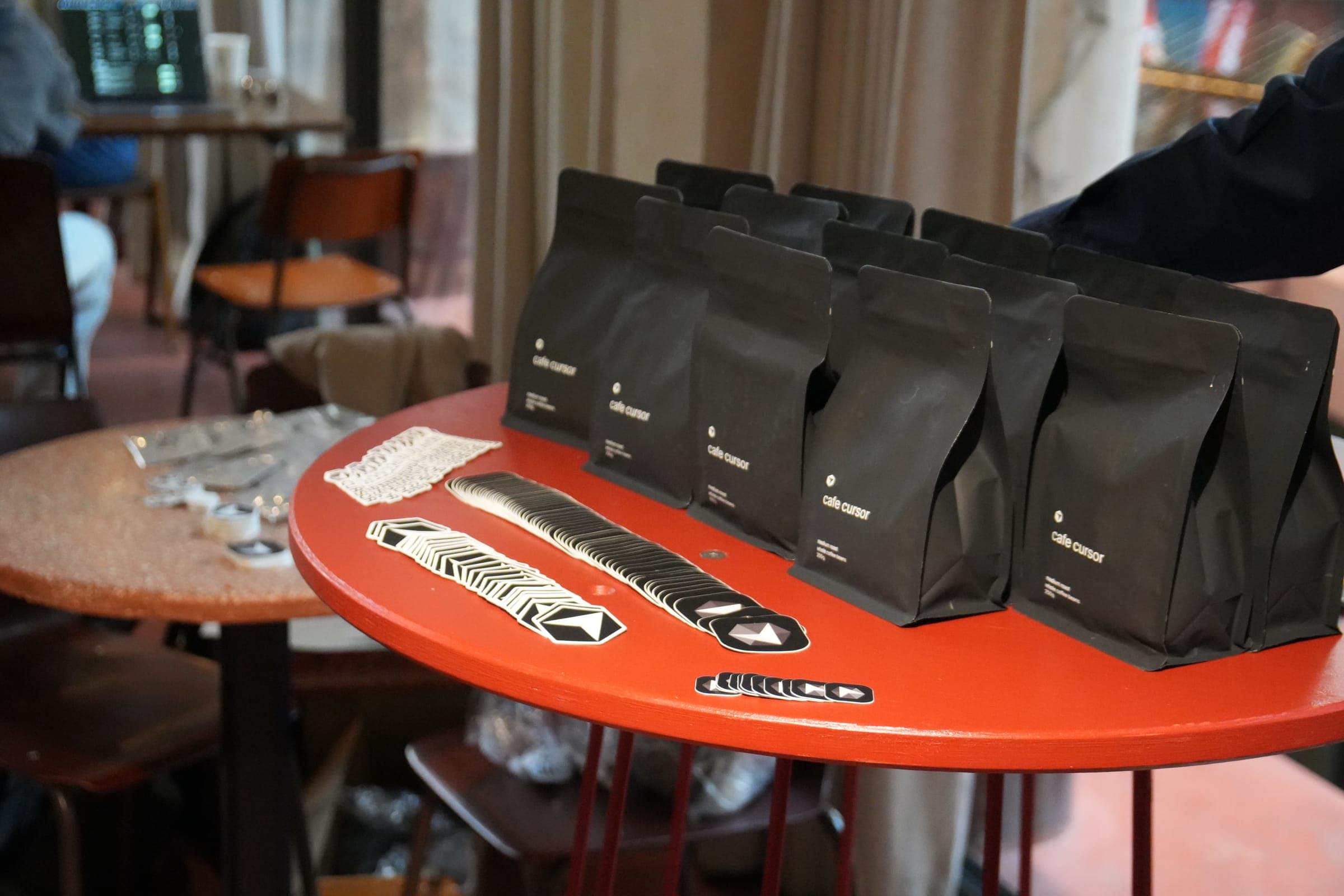 Cafe Cursor Ghent, 23 May 2026. Cafe Cursor coffee bags and Cursor stickers.