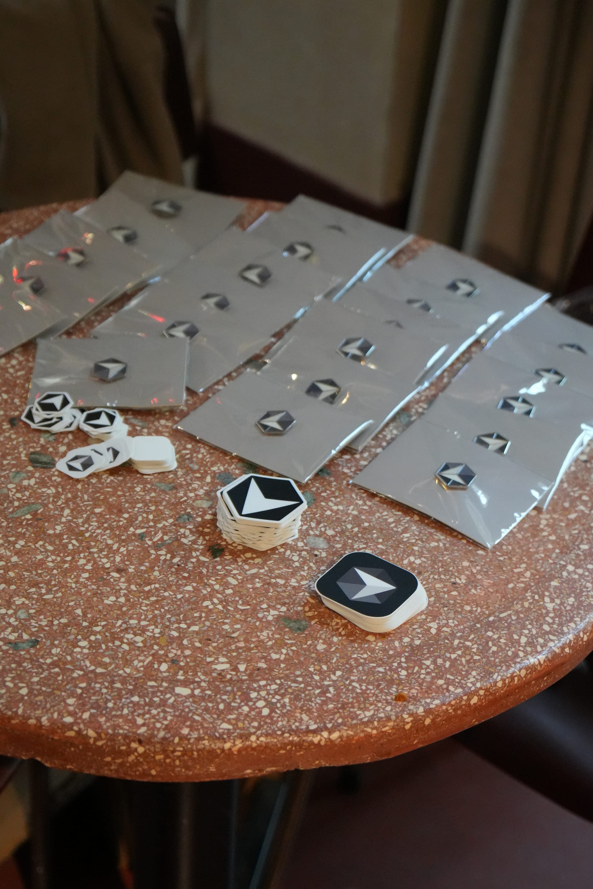 Cafe Cursor Ghent, 23 May 2026. Cursor pins and stickers on a table.