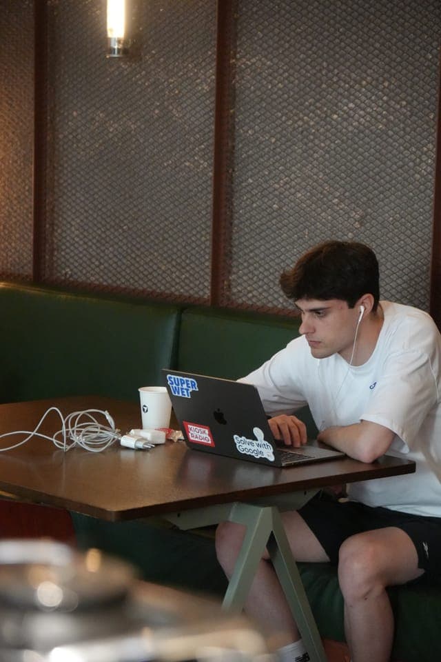 Cafe Cursor Ghent, 23 May 2026. A builder working on a laptop.