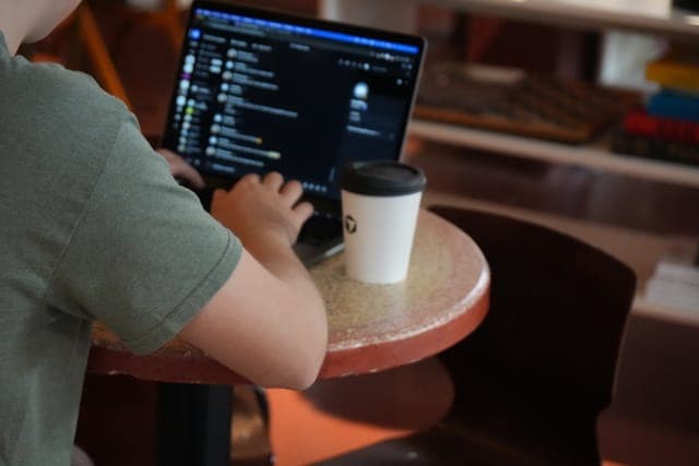 Cafe Cursor Ghent, 23 May 2026. Laptop and coffee on a cafe table.